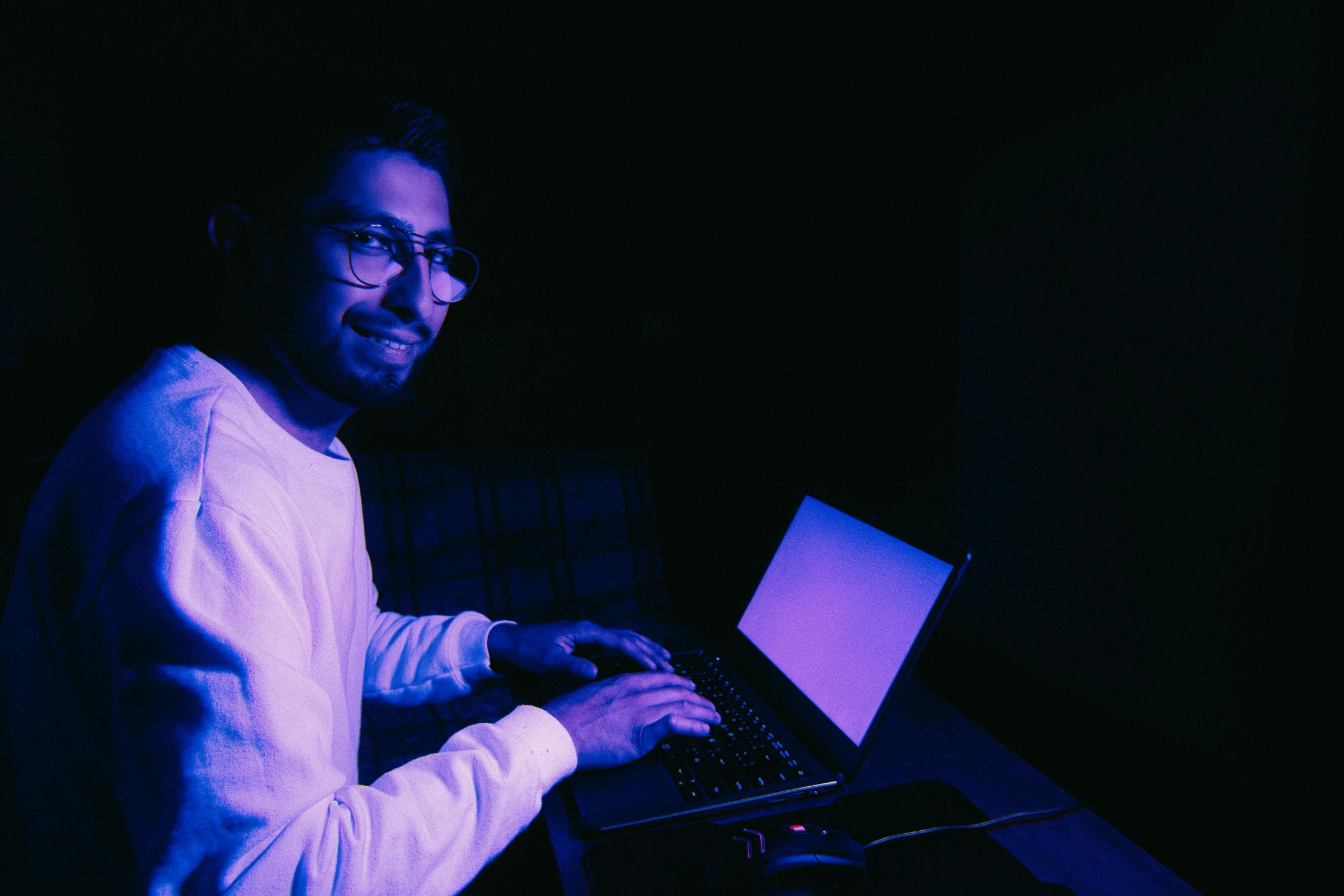 a person working on a laptop with glowing screen