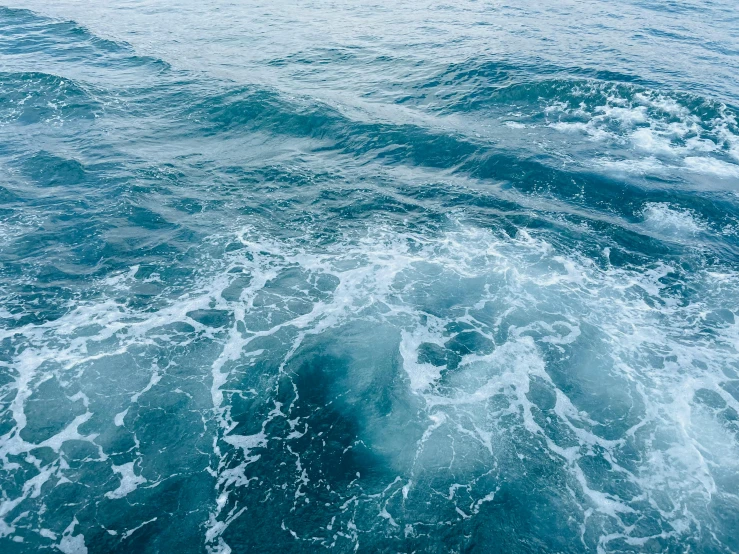 a wave breaking on a boat near land