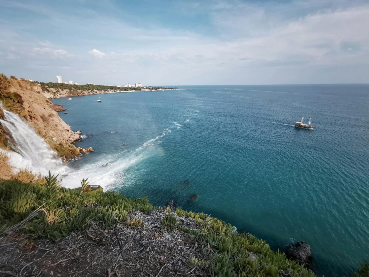 the water is crystal blue with small waves