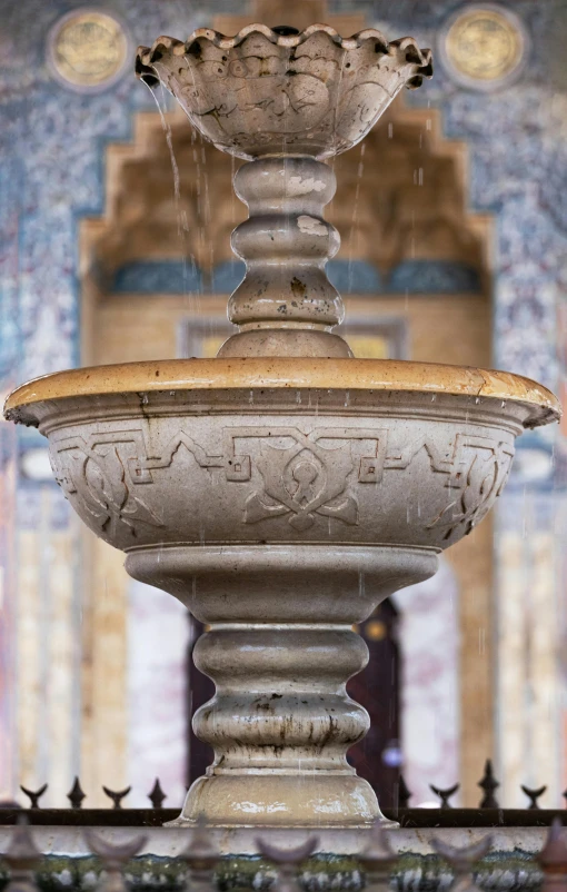 the old fountain is spraying water into the air