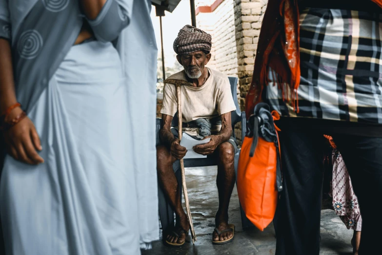 a man sitting on a bench in front of a person