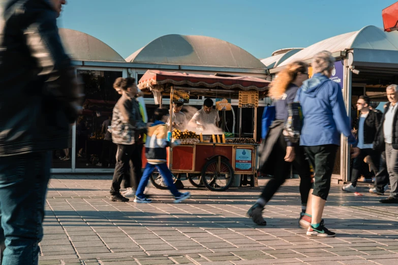 some people walking around in a city square