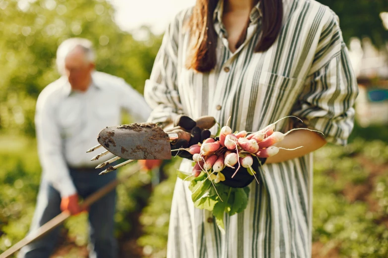 there is a person holding flowers and an old pick shovel