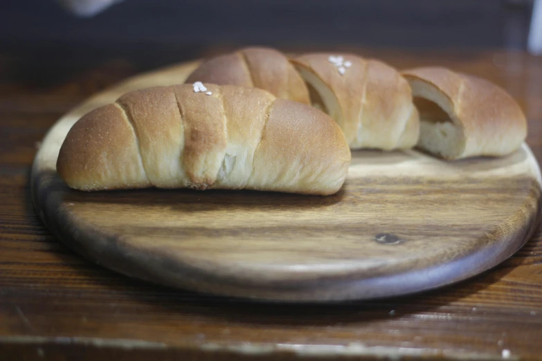 a wooden plate with sliced pieces of bread on it