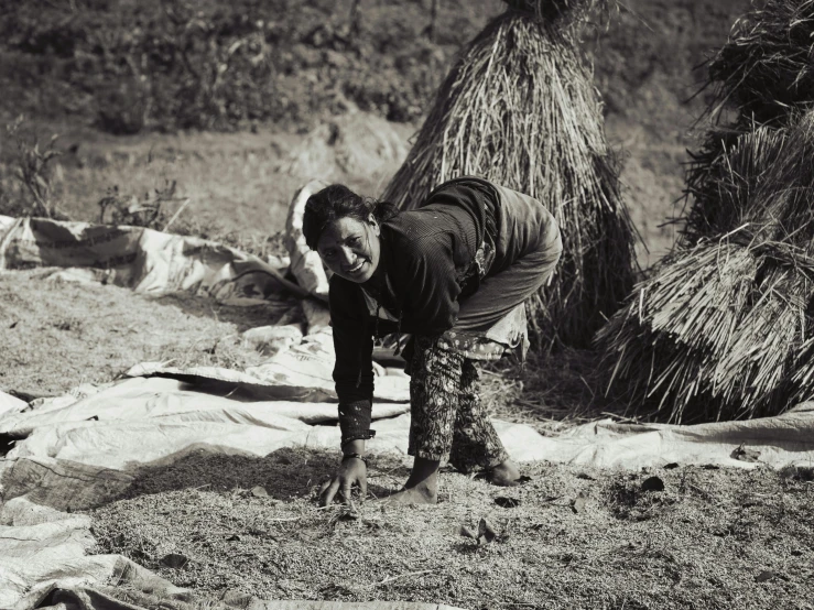 a man standing on his hand near a tree