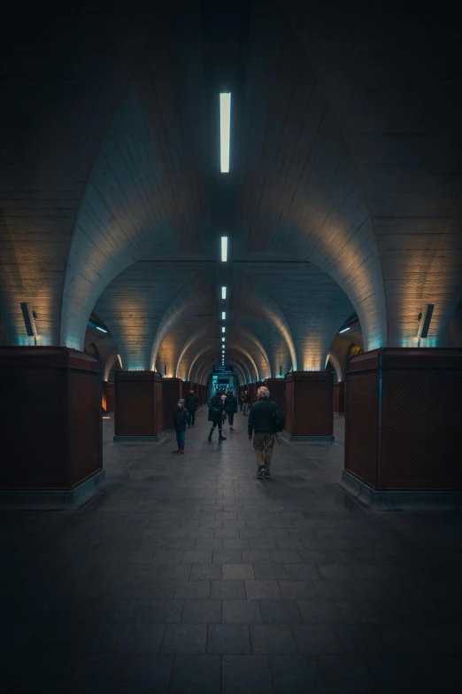 a walkway leading up into an overpass with some people walking on it