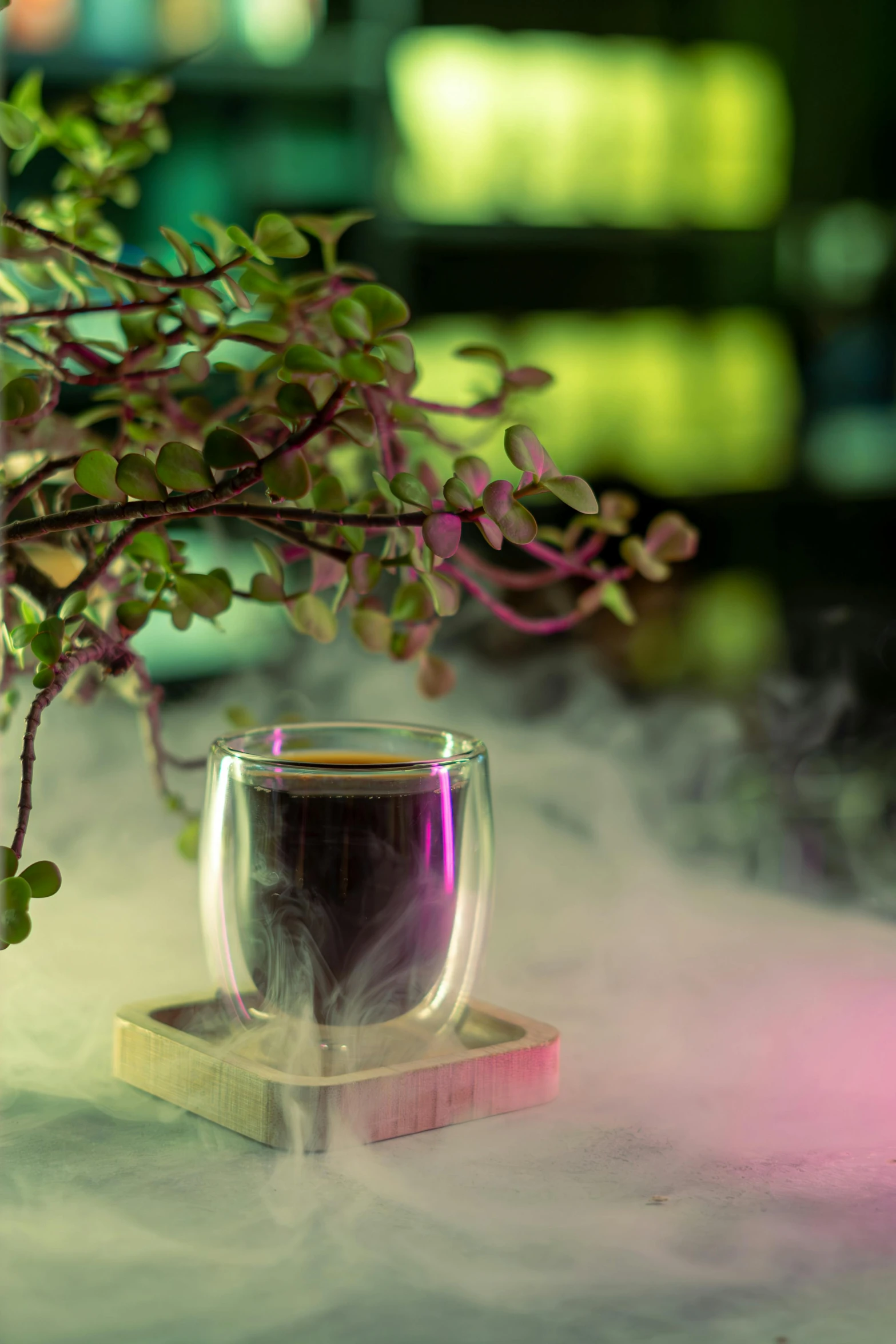 glass cup with smoke in the back on table