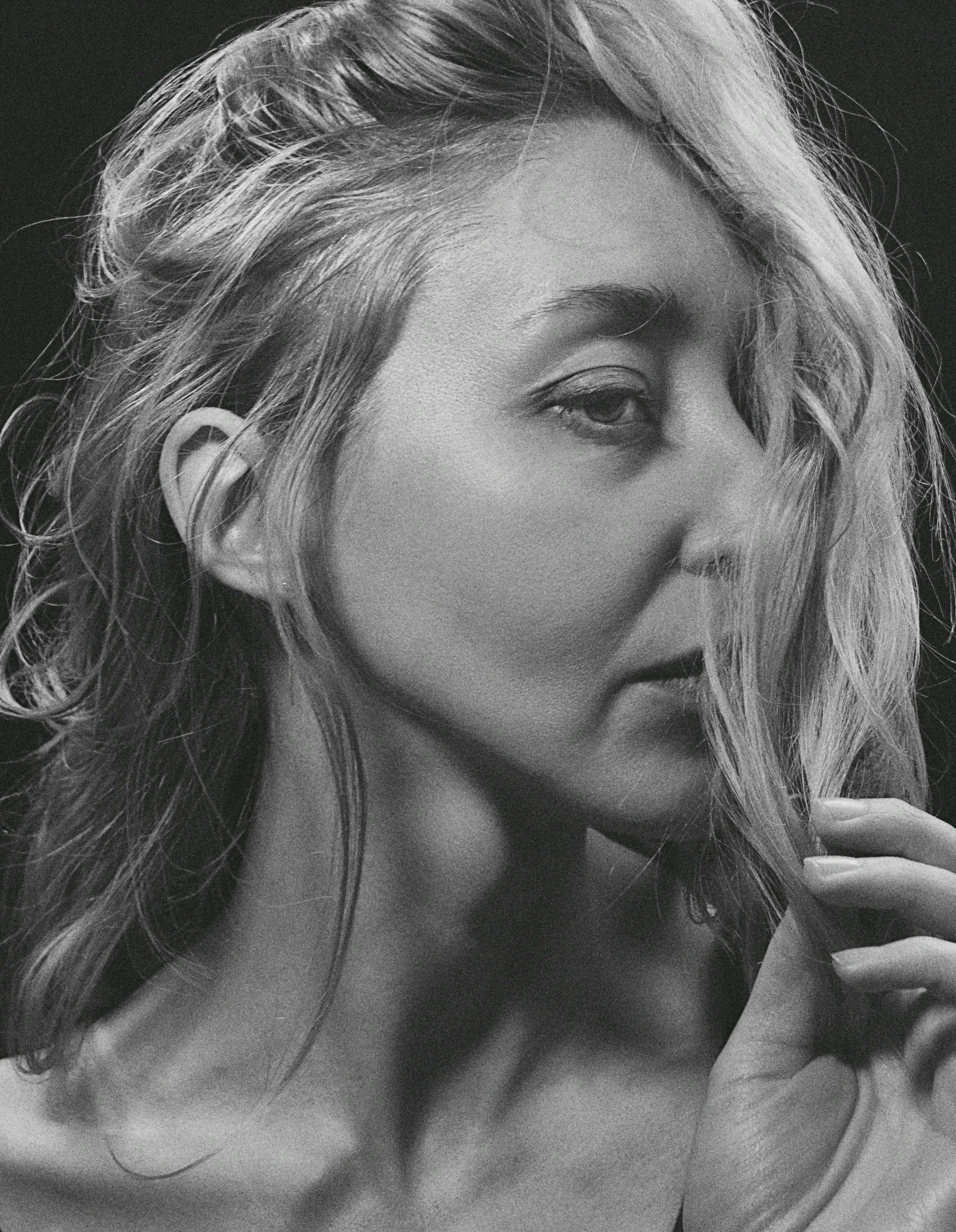 a black and white po of a woman brushing her hair