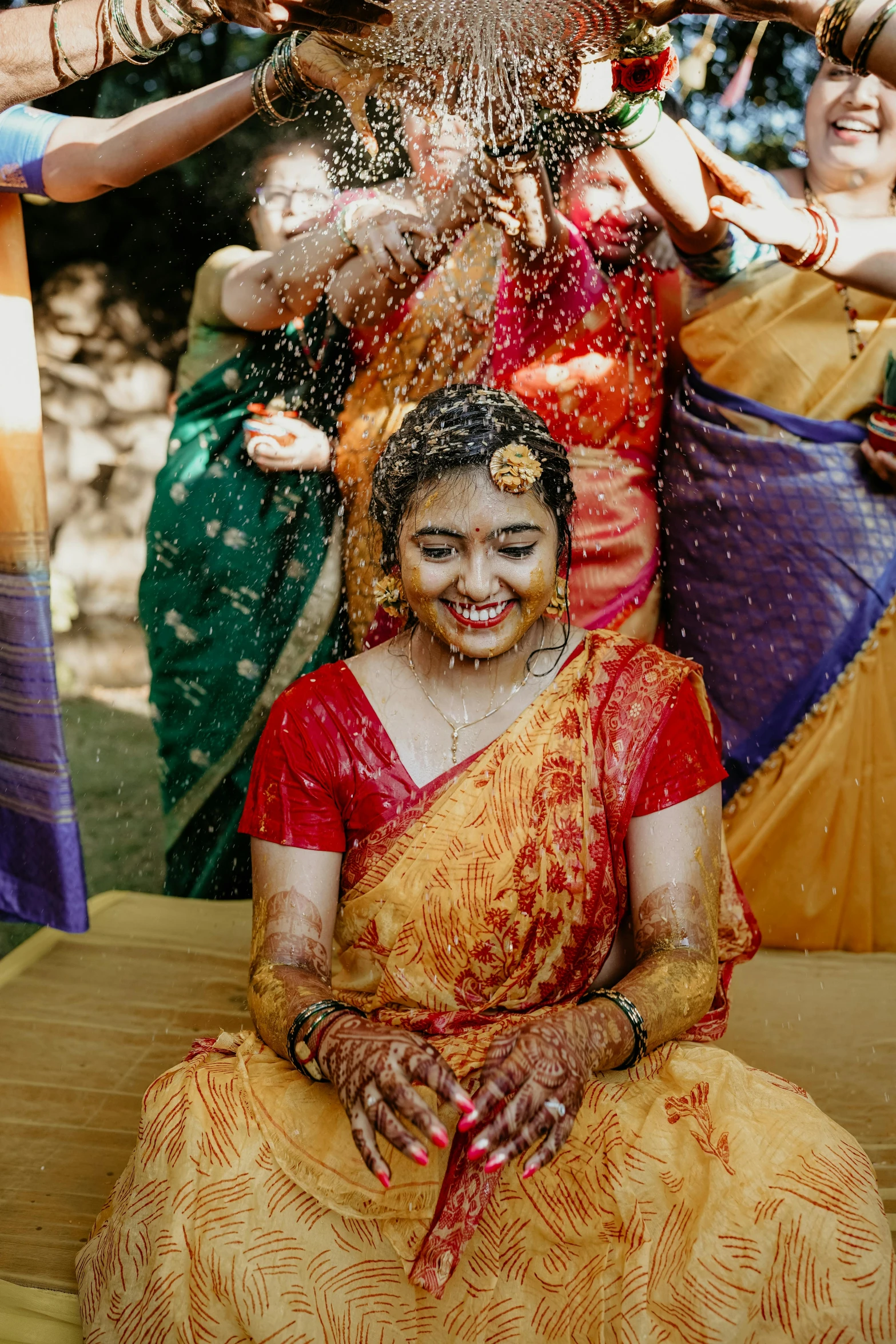 several women are having fun with the water on their faces