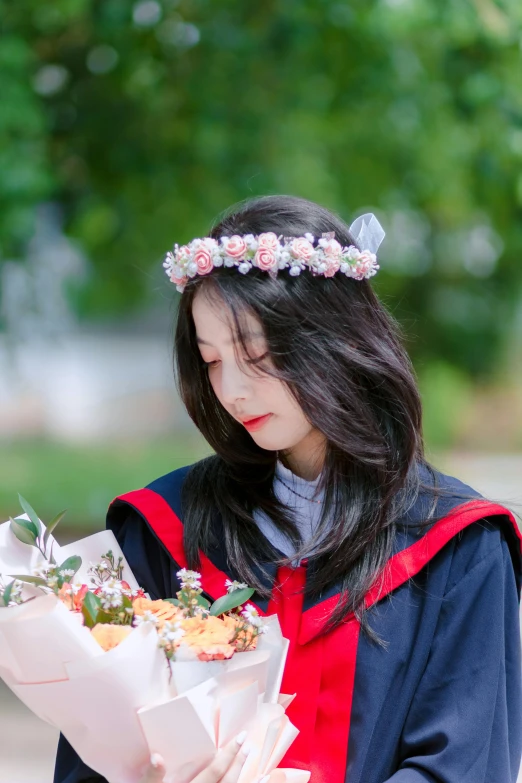 a woman with flowers is holding soing in her hands