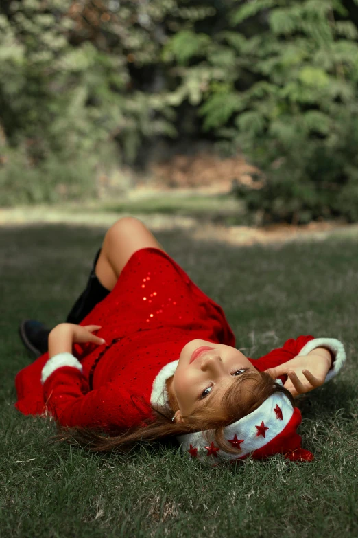 an adorable little girl laying on the grass