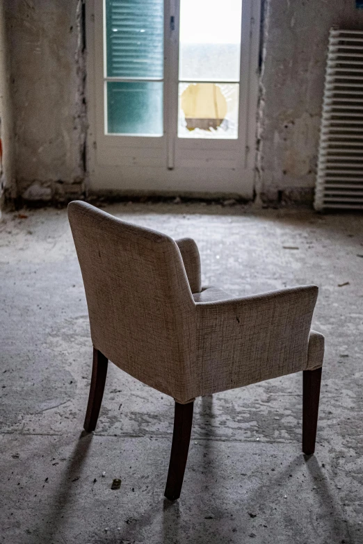 an old chair sits in the room that is now empty