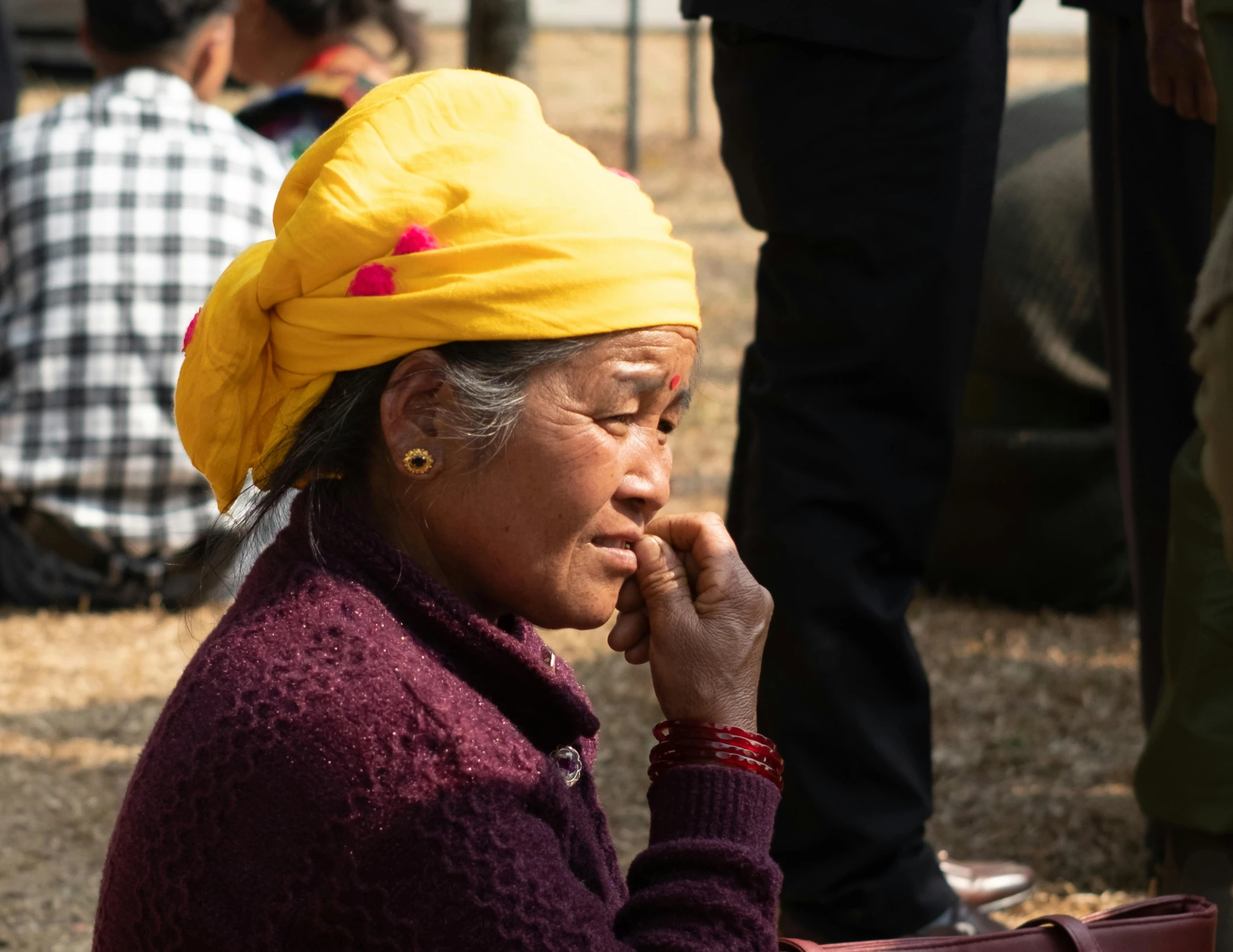 an old woman sitting with her hand under her chin