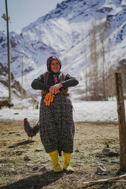 a woman is standing in front of her chickens