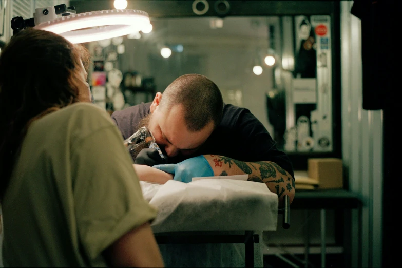 a man getting tattooed in a tattoo shop