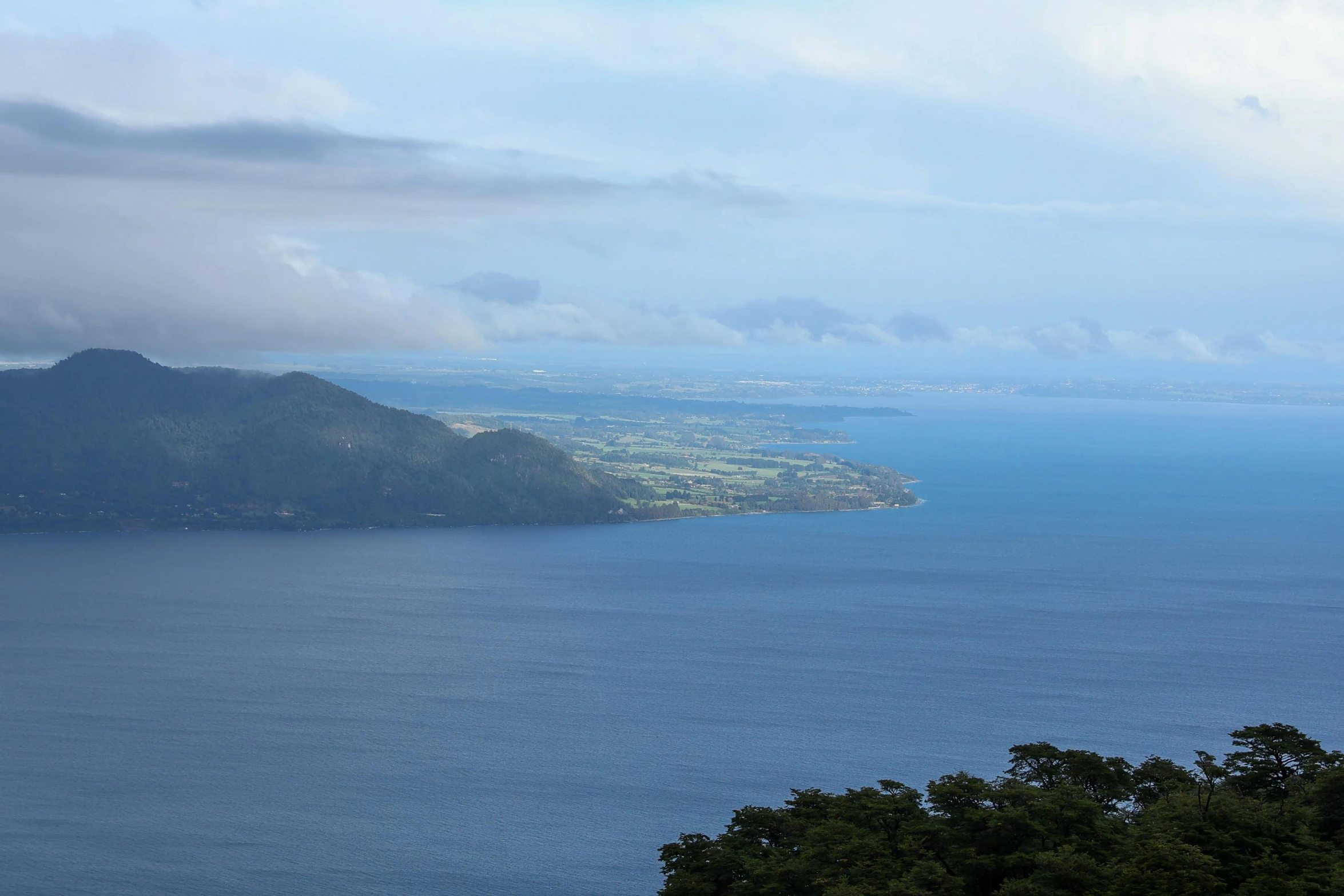 a large body of water with hills on either side