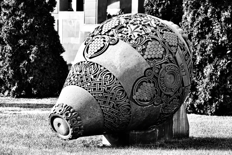 a big sculpture sitting in the middle of some grass