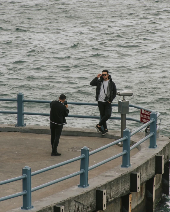 a couple of guys are by the water