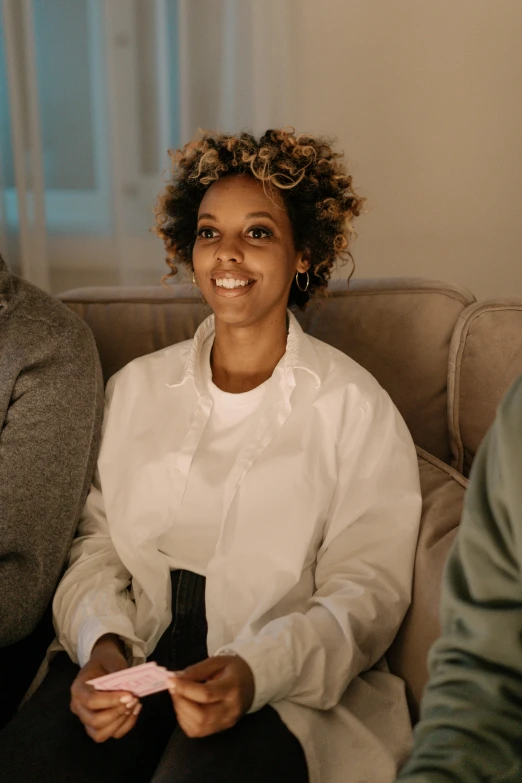 a woman sitting on a couch and smiling