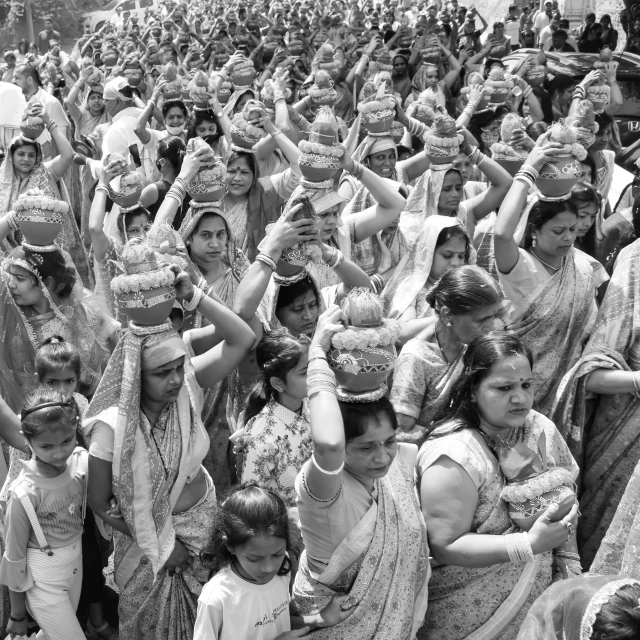 many people wearing white and silver dresses and head coverings