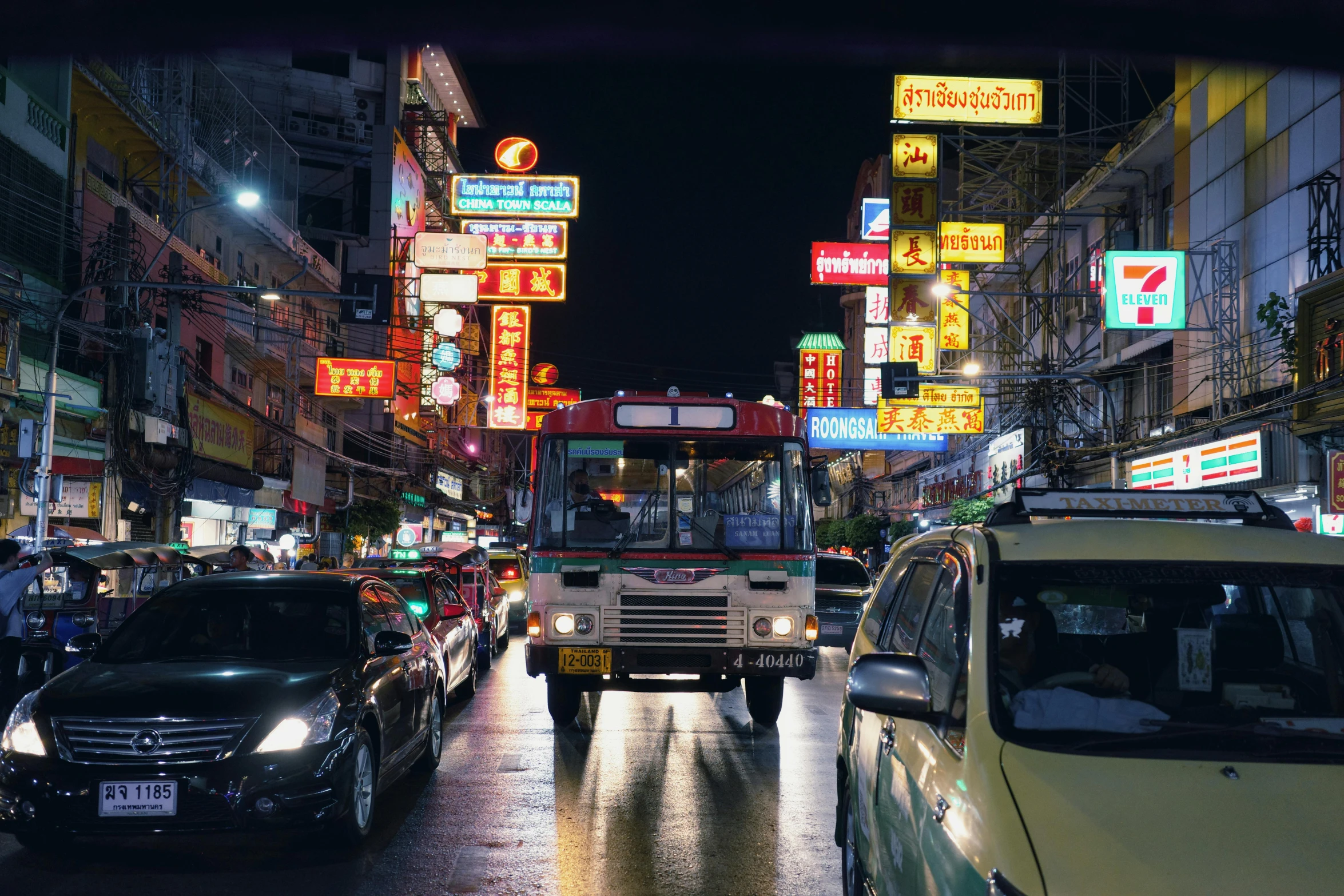 busy city street with cars and signs all around at night