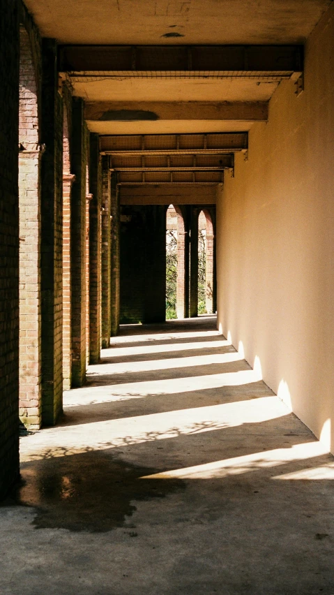 a long corridor with a lot of columns and no people