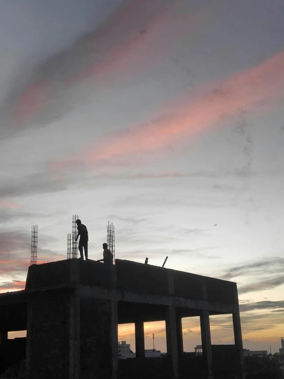 a person is working on a building with a crane