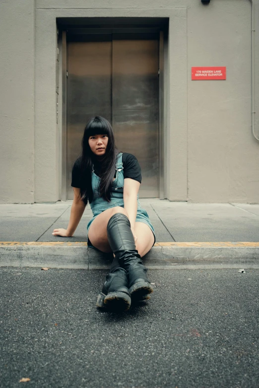 a girl is sitting on the street