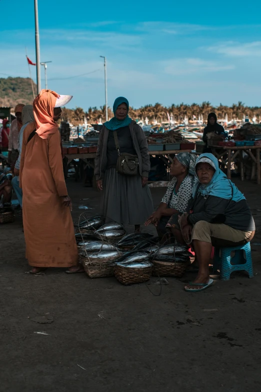 a couple of women in long dress sitting down