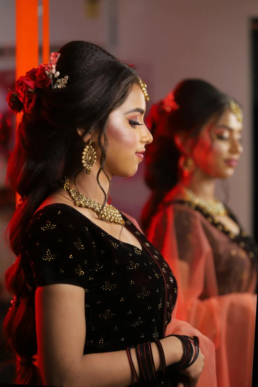 two ladies wearing necklaces and pearls looking off to the side