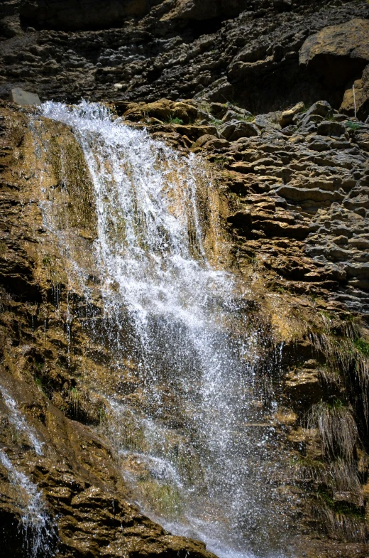 a very tall waterfall filled with water and dust