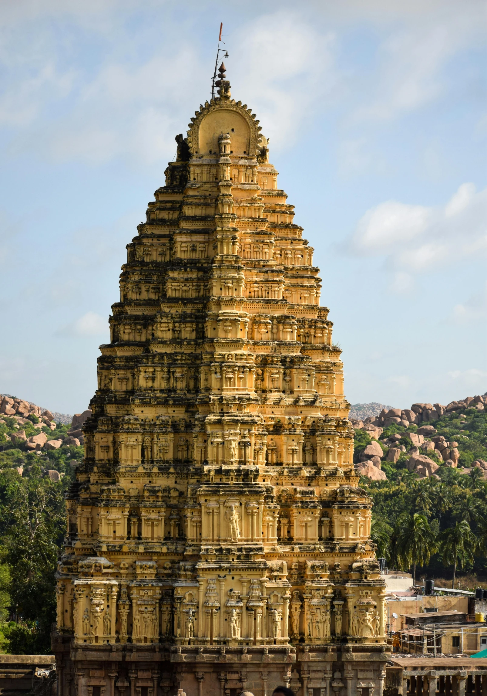 a tall tower in front of a forest