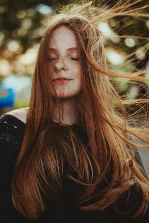 a young woman with long red hair is pographed