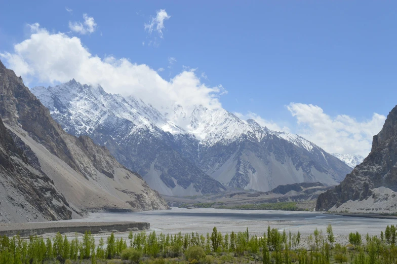 a mountain range is shown behind a body of water