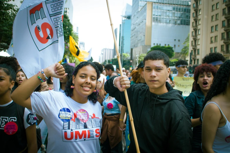 young people standing outside in a city protesting