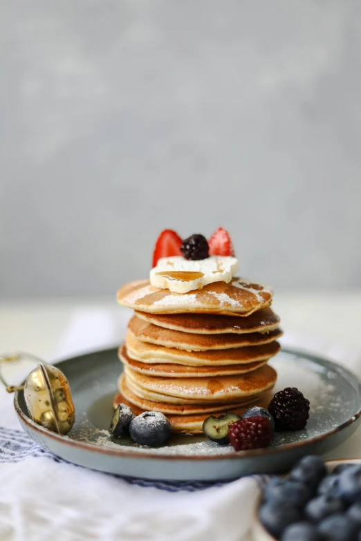 pancakes with berries, milk and whipped cream