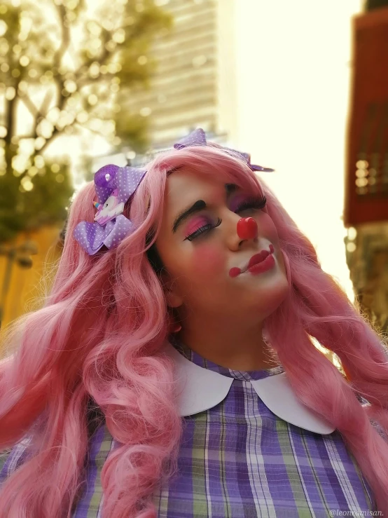 pink hair woman with pink nose and face makeup
