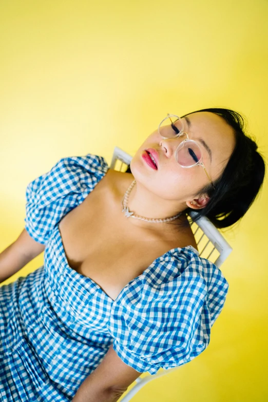 a woman poses with her eyes closed and head turned slightly