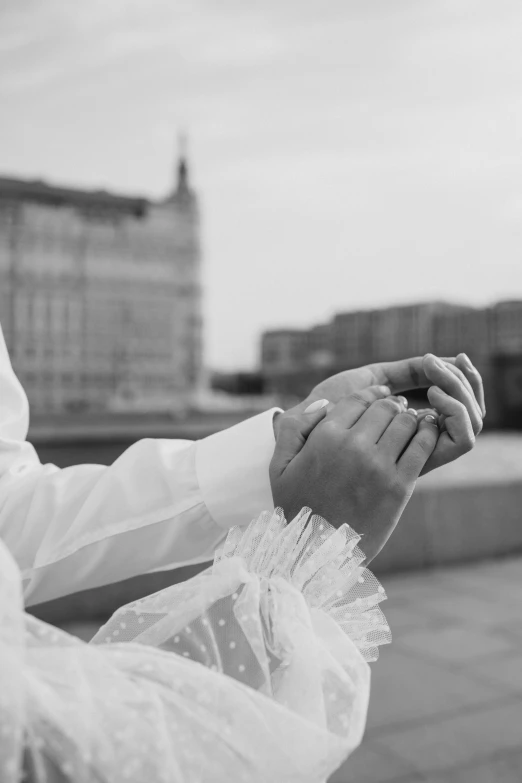 a couple hold hands over the bridge in a black and white po