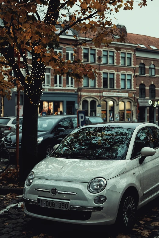 a car parked on a brick paved city street