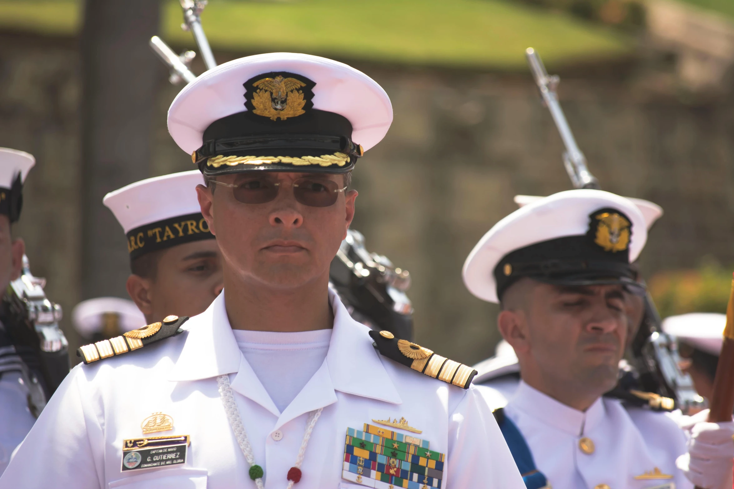 three men dressed in military uniforms standing next to each other