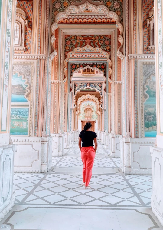 an older woman stands in a marble room