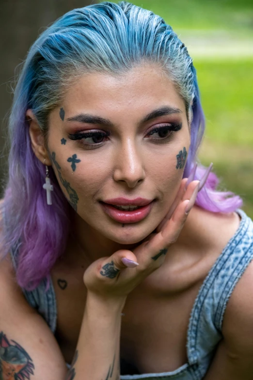 a woman with many tattoos is posing for the camera