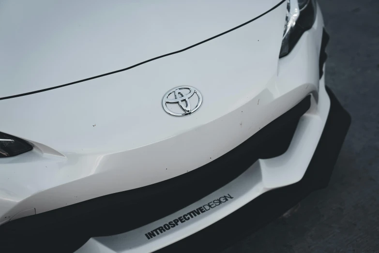 close up of a white car logo
