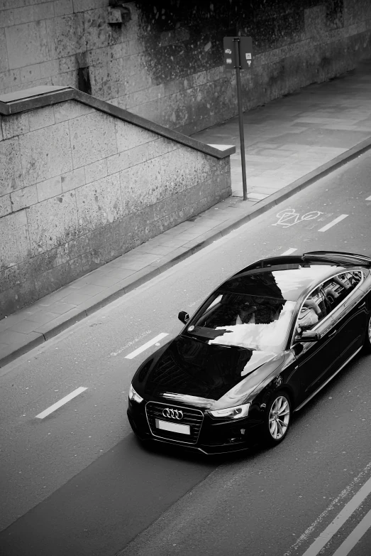 the side of a black sports car on a road