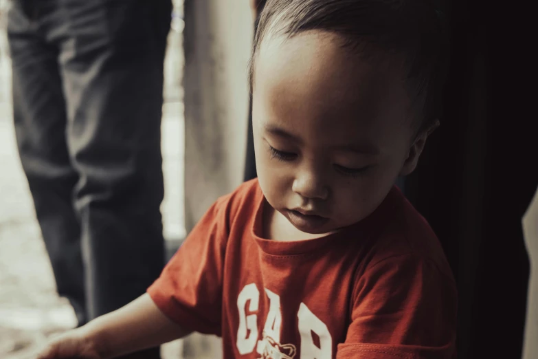 a little boy that is standing next to someone