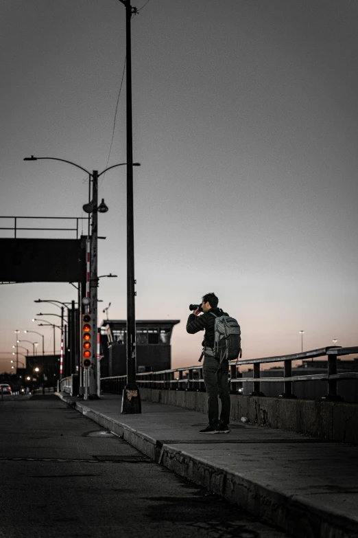 a man taking a po of a street with his camera