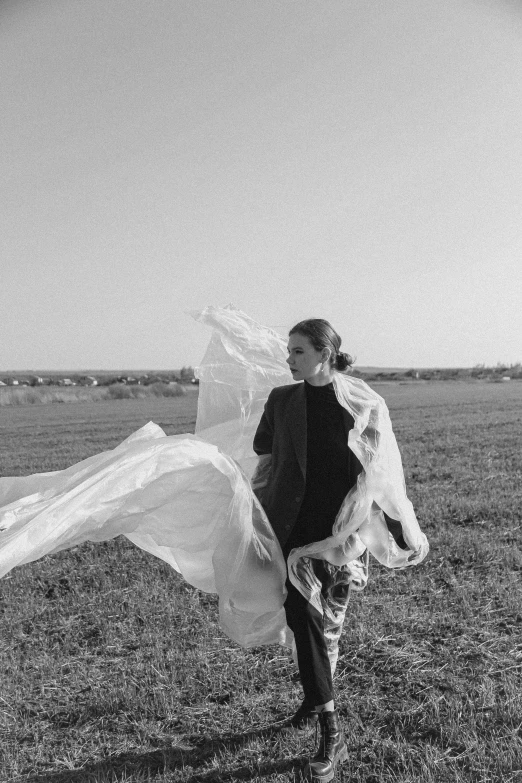 black and white po of a couple walking across a field