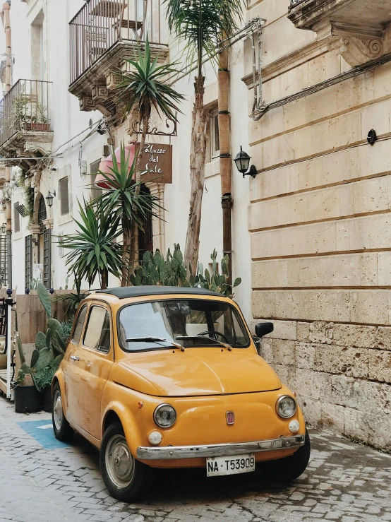 an orange car parked on the side of the road