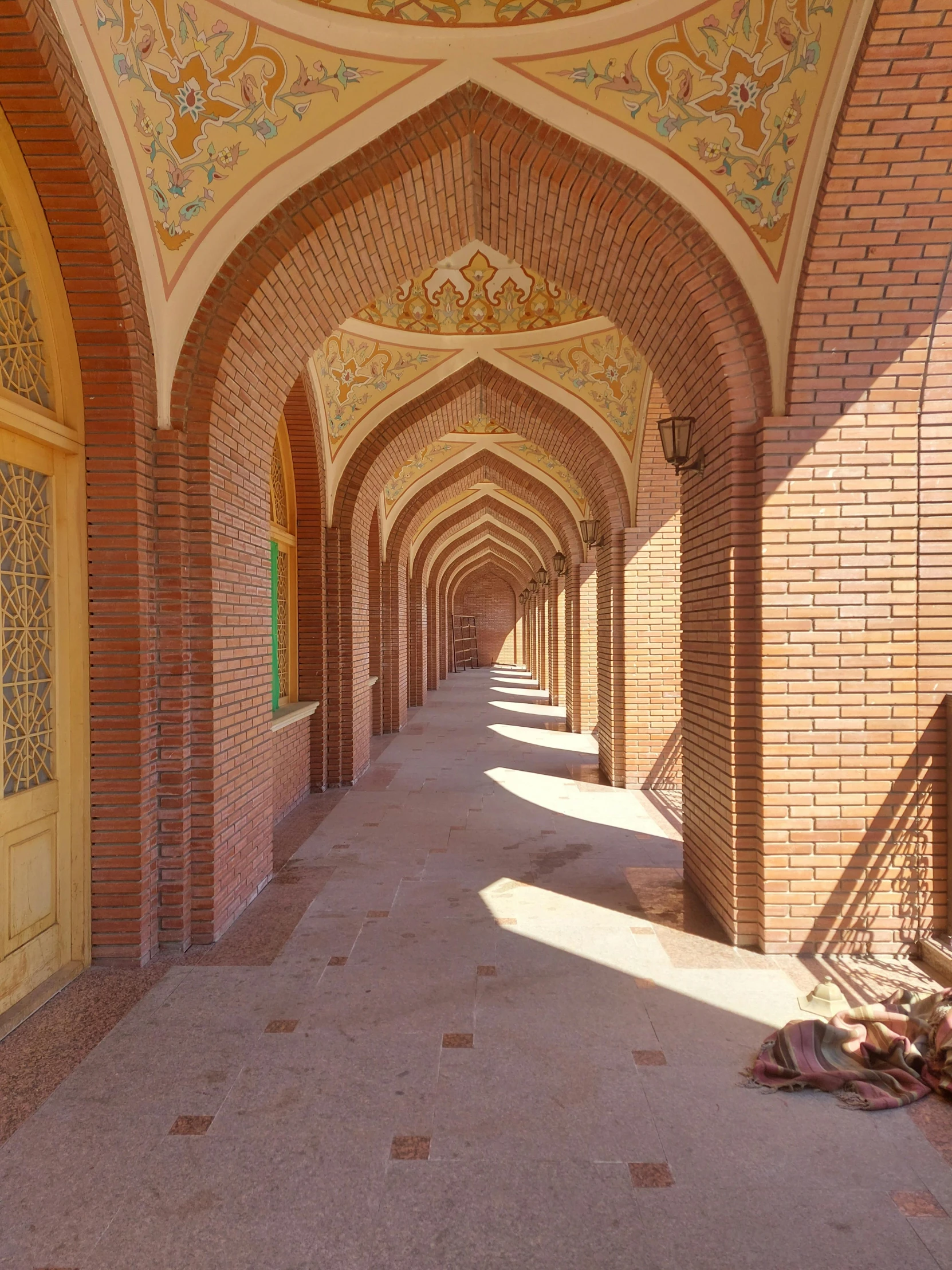 this hallway is lined with stone arches and brick walls